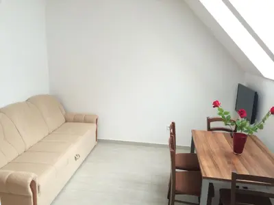 a living room with a couch and a table at Apartmaji Kranjska Gora in Kranjska Gora