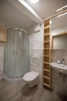 a bathroom with a shower and a toilet and a sink at S Hotel in Maribor