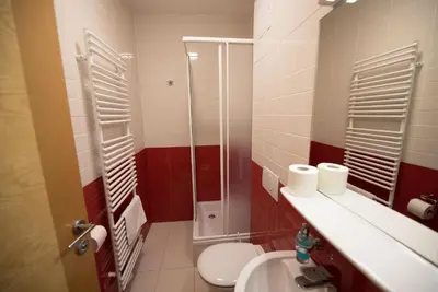 a bathroom with a shower and a toilet and a sink at S Hotel in Maribor