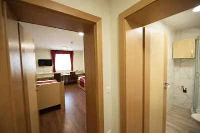 an open door to a room with a bathroom at S Hotel in Maribor