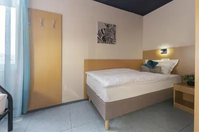 a bedroom with a bed and a zebra picture on the wall at PREMIUM B&B Nova Gorica, Self Check-In with code access in Nova Gorica