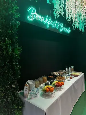 a table with food on it with a sign that reads breakfast banquet at PREMIUM B&B Nova Gorica, Self Check-In with code access in Nova Gorica