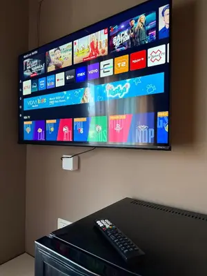 a flat screen tv hanging on a wall with a remote control at PREMIUM B&B Nova Gorica, Self Check-In with code access in Nova Gorica