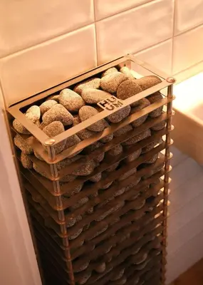 a basket full of rocks sitting on a wall at Designer Riverfront Cottage in Podljubelj