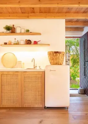 a kitchen with a refrigerator and a sink at Designer Riverfront Cottage in Podljubelj