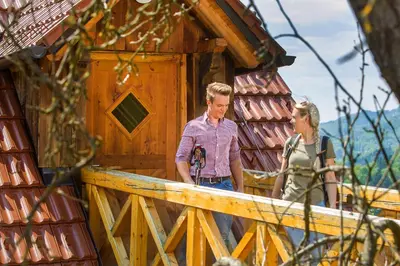 a man and a woman standing outside of a building at Farm Stay Pirc - Hayloft Apartment in Laško