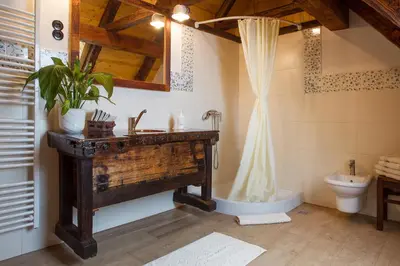a bathroom with a wooden sink and a toilet at Farm Stay Pirc - Hayloft Apartment in Laško