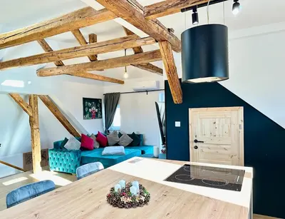 a living room with a blue couch and a table at City Central Loft with Parking in Maribor