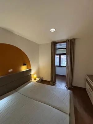 a bedroom with a large bed and a window at Apartma Vila De Casa in Ribnica