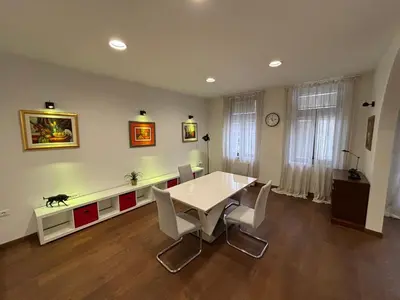 a dining room with a white table and chairs at Apartma Vila De Casa in Ribnica