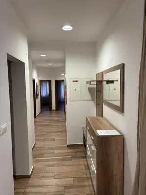 a hallway with white walls and a wooden floor at Apartma Vila De Casa in Ribnica