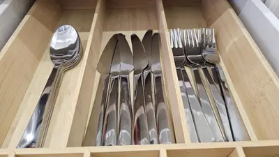 a drawer full of utensils in a wooden box at Teeny tiny in Šentvid