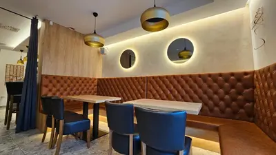 a dining room with a table and blue chairs at Teeny tiny in Šentvid