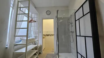 a bathroom with a shower and a glass door at Teeny tiny in Šentvid