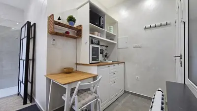 a small kitchen with a table and a microwave at Teeny tiny in Šentvid