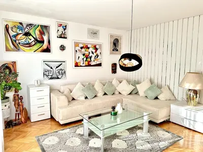 a living room with a couch and a glass table at Colorful Central Apartment in Maribor in Maribor