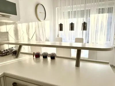 a white table in a room with a window at Colorful Central Apartment in Maribor in Maribor