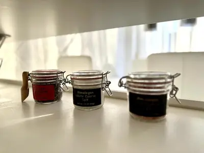 three jars of jam sitting on top of a counter at Colorful Central Apartment in Maribor in Maribor