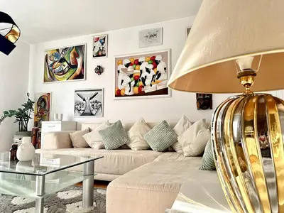 a living room with a couch and a table at Colorful Central Apartment in Maribor in Maribor