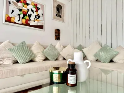 a living room with a couch and a vase on a table at Colorful Central Apartment in Maribor in Maribor