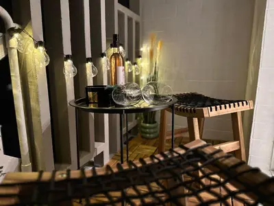 a table with wine glasses and a bottle on it at Colorful Central Apartment in Maribor in Maribor