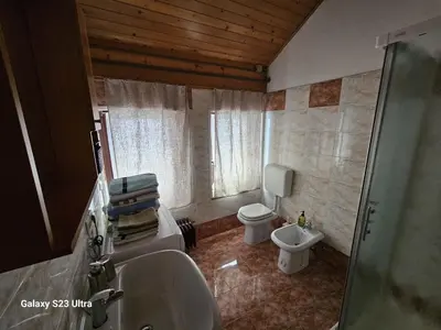 a bathroom with a sink and a toilet and a window at Avecchiasegheria in Most na Soči