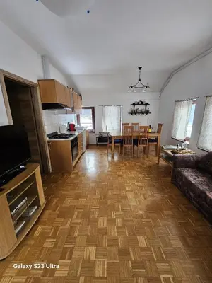 a kitchen and living room with a couch and a table at Avecchiasegheria in Most na Soči