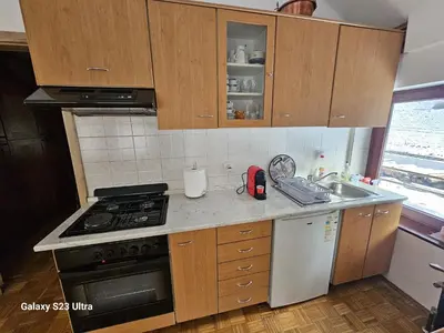 a kitchen with a sink and a stove top oven at Avecchiasegheria in Most na Soči