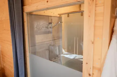 a glass door of a shower in a room at Studio Wild Park Panorama with Hot tub and Sauna in Tolsti Vrh pri Ravnah naKoroškem