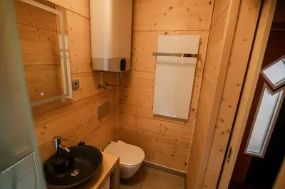 a small bathroom with a toilet and a sink at Studio Wild Park Panorama with Hot tub and Sauna in Tolsti Vrh pri Ravnah naKoroškem