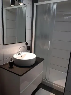 a bathroom with a sink and a mirror and a shower at Apartments Isabella in Ptuj