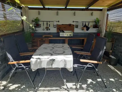 a table and four chairs in a patio at Apartments Isabella in Ptuj
