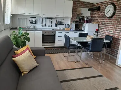 a living room with a couch and a table with chairs at Apartments Isabella in Ptuj