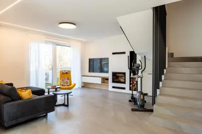 a living room with a couch and a tv at Hiša Urma in Celje