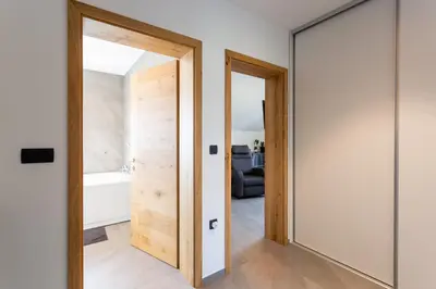 a hallway with two doors and a mirror at Hiša Urma in Celje