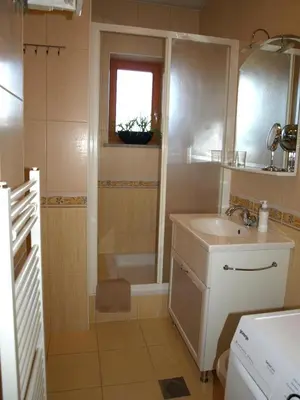 a bathroom with a sink and a shower and a tub at Apartament VISOTA in Ptuj