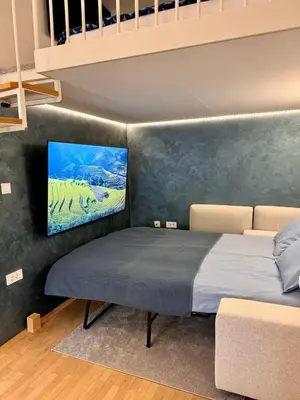 a bedroom with a bed with a painting on the wall at Staro mesto & Dragon bridge in Ljubljana