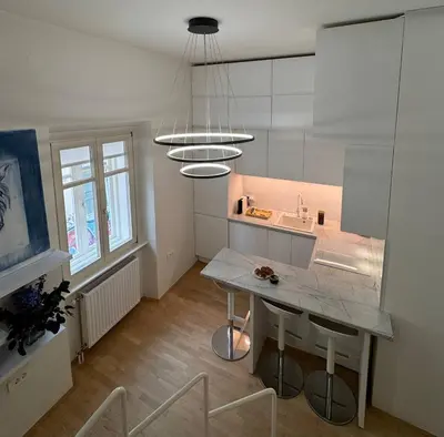 a kitchen with a table and a counter top at Staro mesto & Dragon bridge in Ljubljana