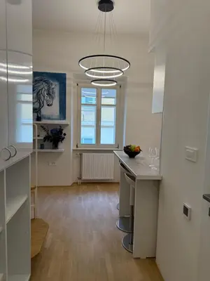 a kitchen with a table and a large chandelier at Staro mesto & Dragon bridge in Ljubljana
