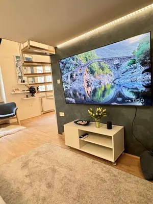 a living room with a large flat screen tv on a wall at Staro mesto & Dragon bridge in Ljubljana