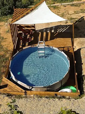 a swimming pool with a ladder in a tent at Holidayapartement Sentjur 2 pers in Šentjur