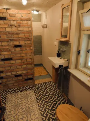 a bathroom with a sink and a brick wall at Holidayapartement Sentjur 2 pers in Šentjur