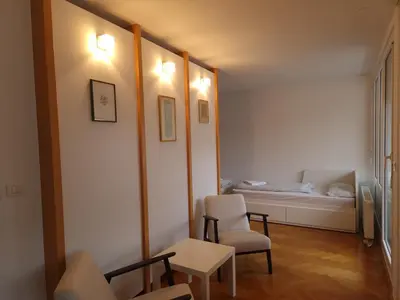 a living room with a bed and a table and chairs at Heart of Ljubljana with free parking in Ljubljana