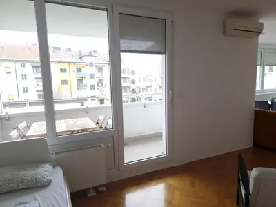 a room with a large glass door with a balcony at Heart of Ljubljana with free parking in Ljubljana