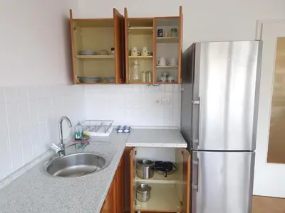 a kitchen with a sink and a refrigerator at Heart of Ljubljana with free parking in Ljubljana