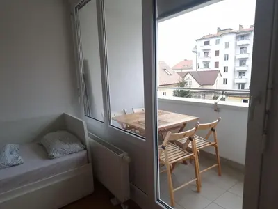 a small balcony with a table and a window at Heart of Ljubljana with free parking in Ljubljana