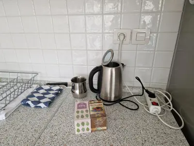 a counter top with a coffee pot and a tea kettle at Heart of Ljubljana with free parking in Ljubljana