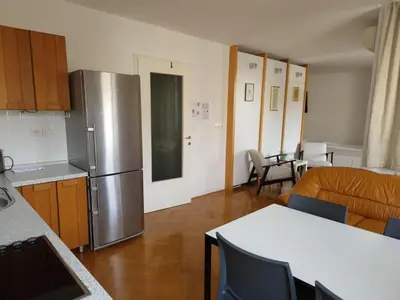 a kitchen with a stainless steel refrigerator in a room at Heart of Ljubljana with free parking in Ljubljana
