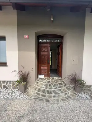 a door to a building with plants in front of it at Apartments LESKOVAR in Ormoz