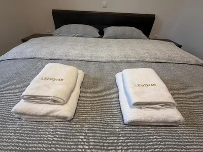 a bed with two towels on top of it at Apartments LESKOVAR in Ormoz